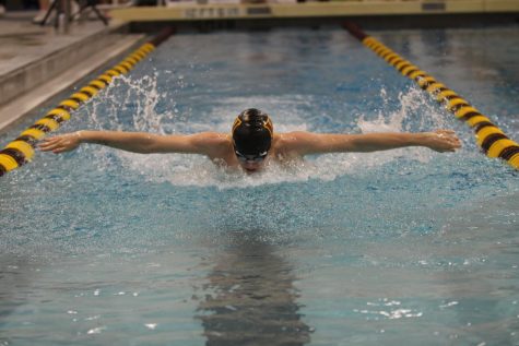 Jacob Wygal (10, Severance) swims butterfly during the March 23 meet against Broomfield. The aqua wizards are working hard this season to push for a chance at winning state. (Leah Bacon)