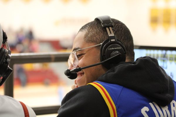 Rize Simmons (11) announces during a girls basketball game. WWBN offers this authentic opportunity for students to learn about broadcasting.