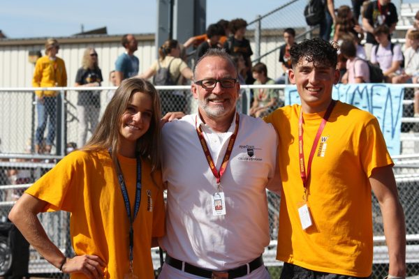 Julia Bohlinger (12) and Johnnie Reed (12) pose with Dr. Tom Dodd (staff), Windsor principal. Bohlinger, Reed and Dodd helped run the first pep assembly of the school year. 