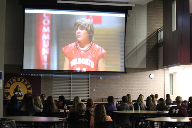 Students watch “High School Musical” during the movie night in the cafeteria. Student Council hosted this movie night, which was a new addition to homecoming week.