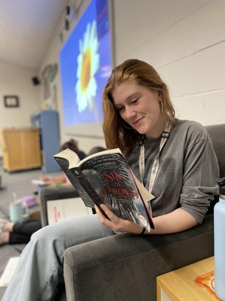 Sage Anderson (12) reads Six of Crows by Leigh Bardugo. Six of Crows is about a group of outcast thieves working together to complete a nearly impossible heist.