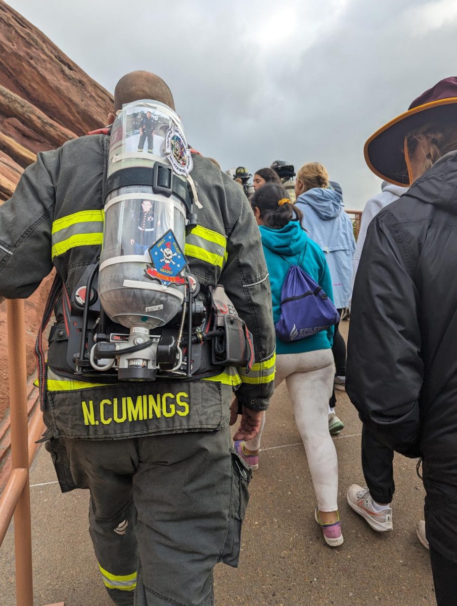 Firefighter Nicholas Cumings climbs the stairs at Red Rocks Park and Amphitheatre on Sept. 11. The cross-country team attended to commemorate the firefighters who supported recovery in the wake of 9/11.