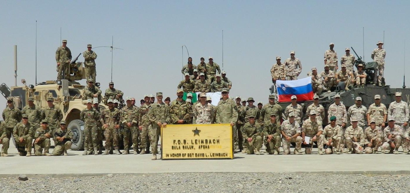 The full unit of soldiers from Slovenia and the United States pose in front of their vehicles. These soldiers, including Jerrod Griebel (staff) were all a part of a joint operation in Afghanistan.