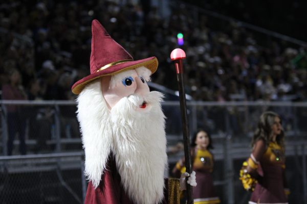 Walter the Wizard holds his staff at the homecoming football game. He just received the staff, made by the robotics team and art club, earlier that day during the homecoming assembly.