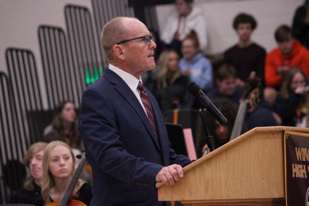 Assistant principal Dick Thomas (staff) shares a speech at the Veterans Day assembly. Principal Tom Dodd (staff), veteran Bill Tomlin and Student Council members also delivered speeches. 