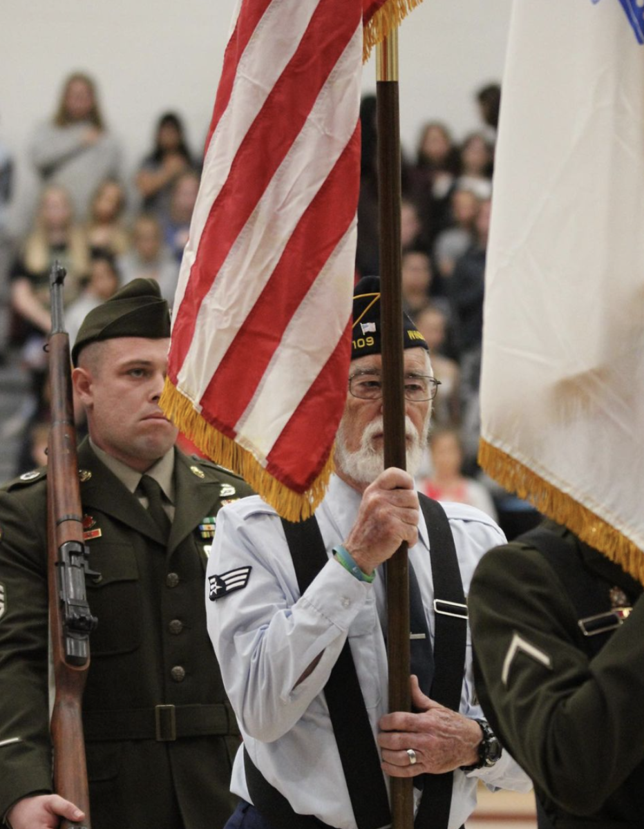 Porth stands and marches during the WHS Veterans Day assembly on Nov. 11, 2022. He has continued his legacy of service by volunteering with first graders at Tozer weekly.