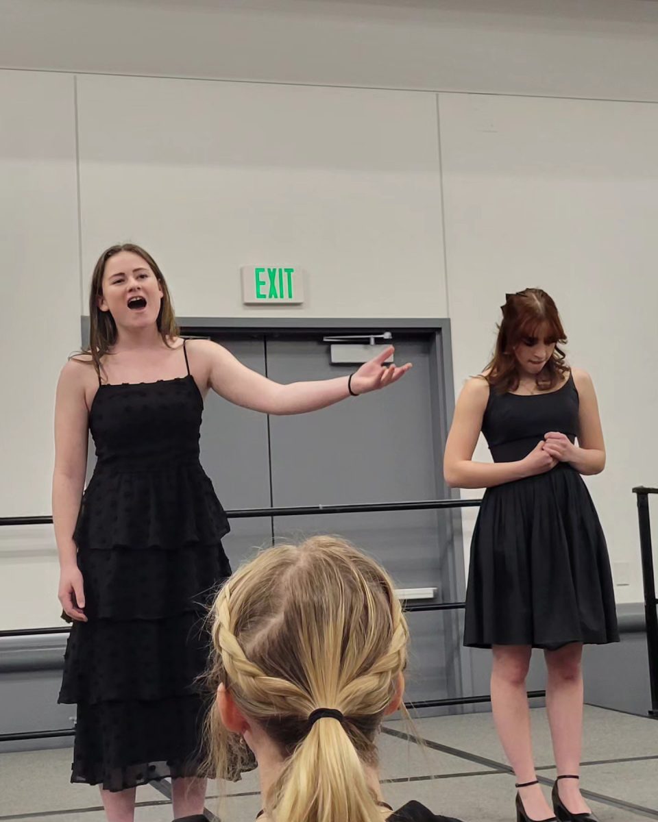 Leah Gilmore (11) sings during her duet with Opal Schlessman (12). Gilmore and Schlessman have been working on their duet for Thescon since summer. 