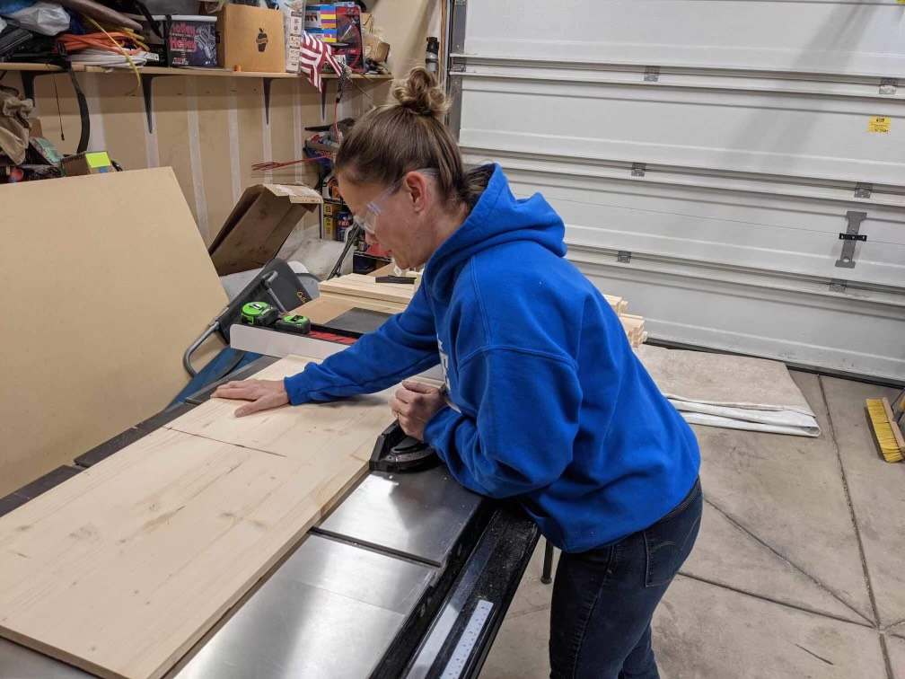 Amanda Kendrot (staff) cuts wood slabs on her work bench. She is one of several WHS teachers who have side businesses and work hard to keep up during the holiday season.