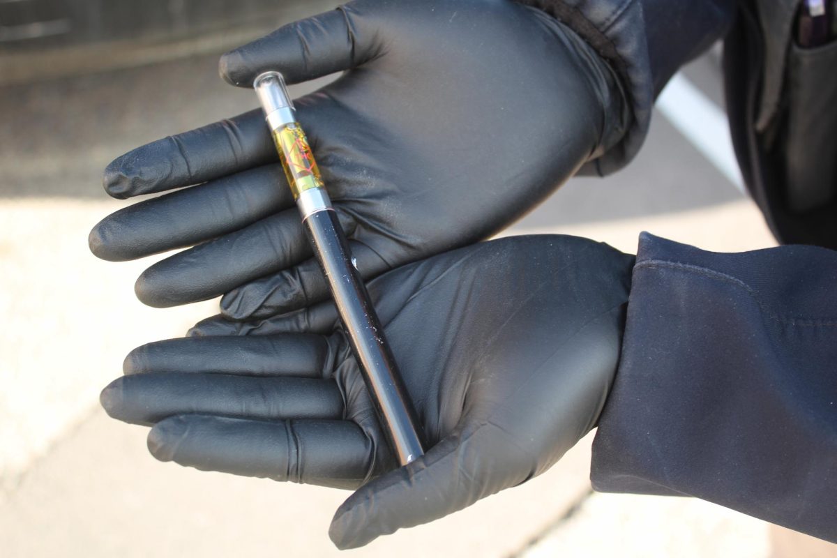 Officer holds a vape confiscated from a high school student. WHS invested in Halo Chemical Detection systems designed to alert staff in the event of students vaping in restrooms.  