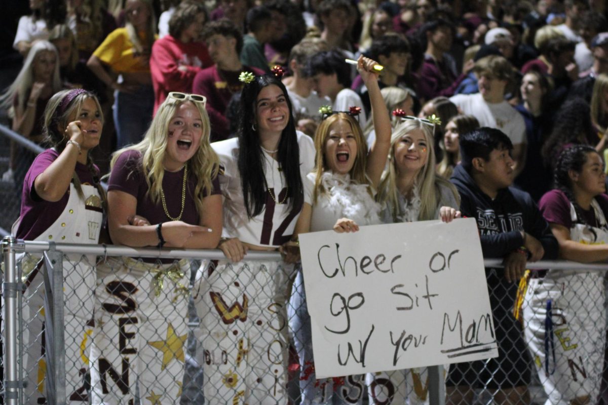 Alexa Strohman (12), Holland Luedtke (12), Jada Scifres (12), Hannah Ingraham (12) and Emma Lyons (12) cheer during the homecoming football game. Luedtke is sad to leave lots of friends but is excited to attend University of Hawaii at Manoa in the fall.