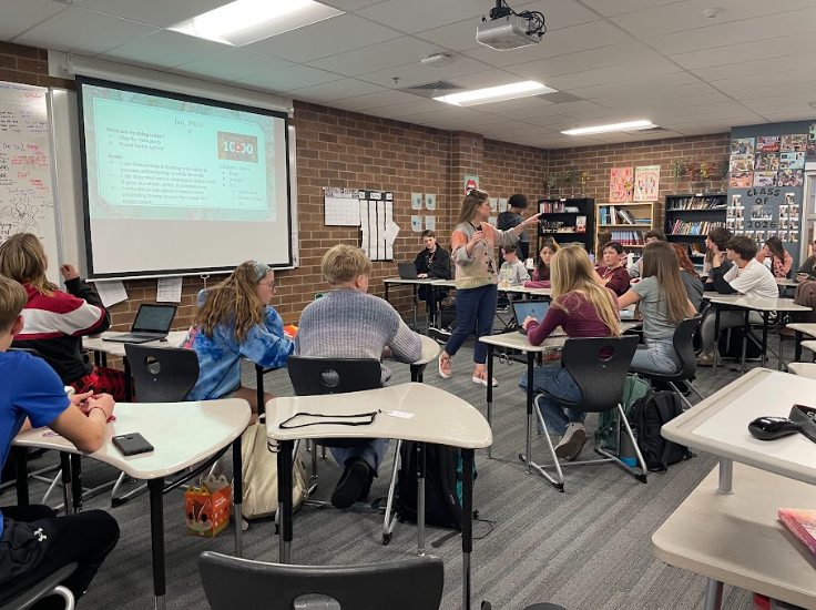 Kjersten Johnson (staff) discusses the days agenda with her freshmen students. The students were preparing for their final project recording of I Dream a World.