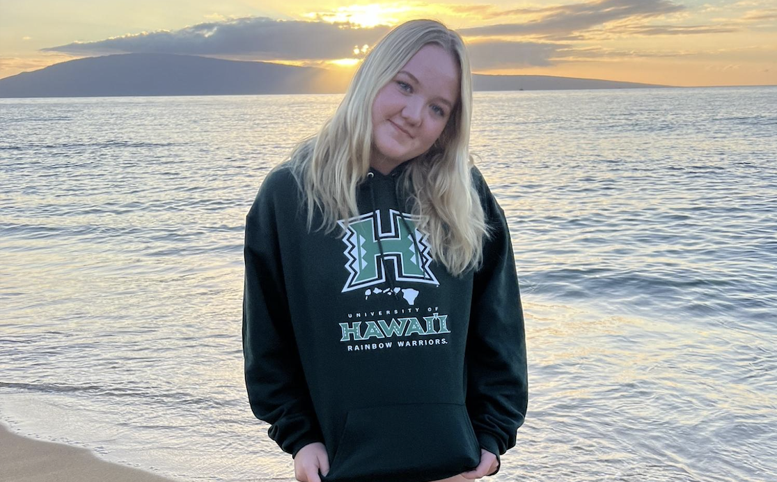 Holland Luedtke (12) stands on the beach in a University of Hawaii sweatshirt. Luedtkes acceptance into the school has made her peers and teachers proud.