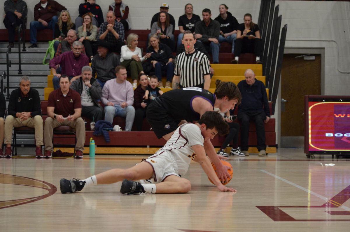 Brady Kingsley (10) gets pushed to the ground after a fight for ball possession. This move earned a penalty for Holy Family during the third quarter of the game. 