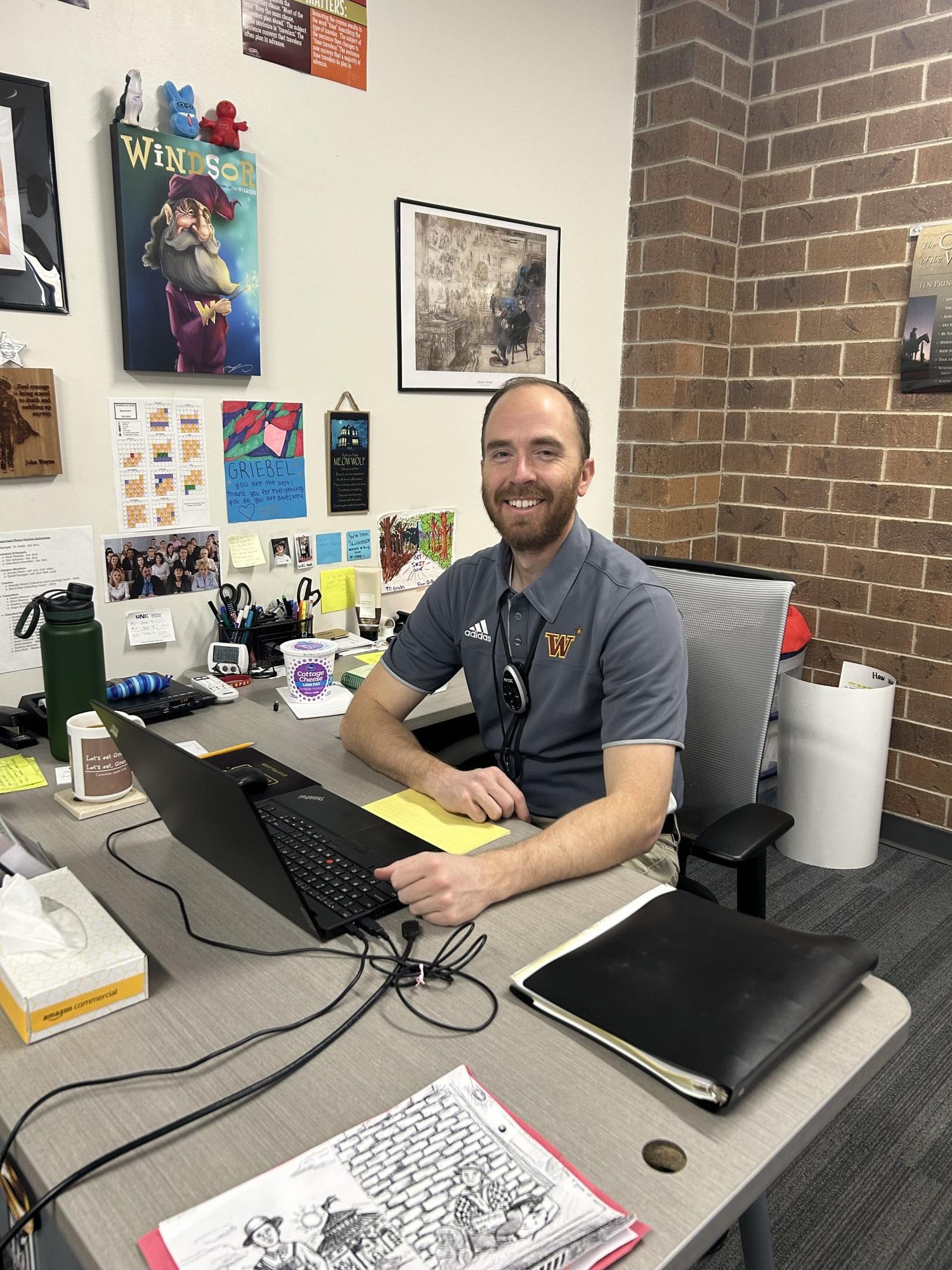 Jerrod Griebel (staff) smiles while sitting at his desk. Griebel said, Imitate the testing environment of the best possible degree that you can.