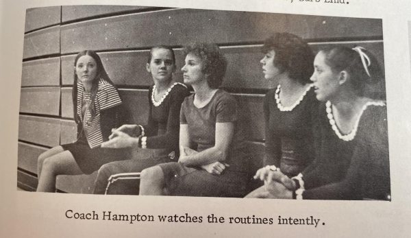 Doyleene Hampton watches a gymnastics routine as seen in a photo from the 1977 WHS yearbook. Hampton started womens sports at WHS. (1977 Wizard)