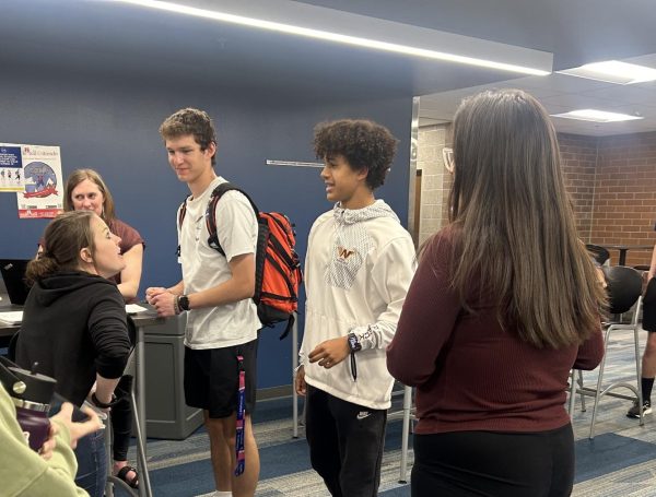 New Link Crew members, including Tristyn Bruning (11) and Kale Frederick (11), collaborate with Cammie Smith (staff), one of the Link Crew advisers, in the upper collab space. The meeting was for new Link Crew members to prepare for their leadership role in the fall. 