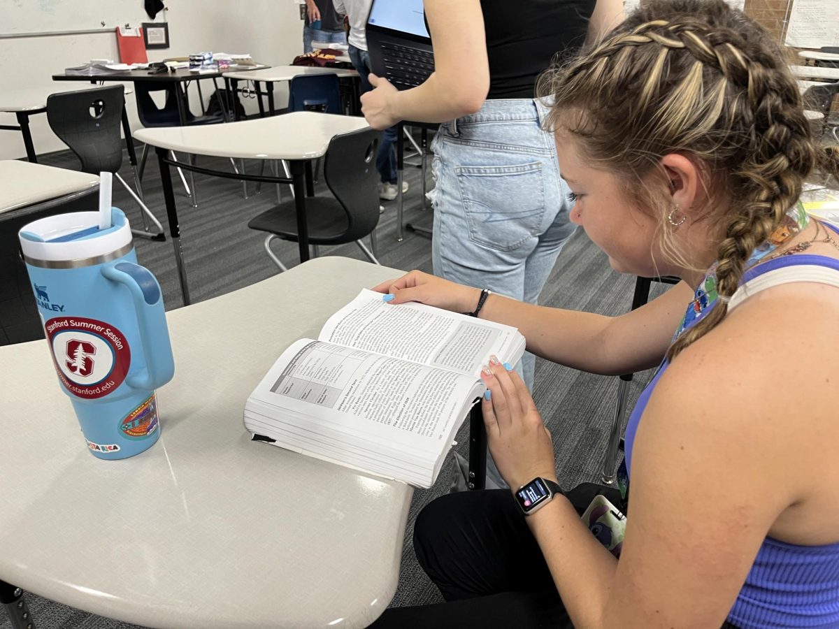 Delaney Kintz (11) reads her AP United States History textbook to prepare for the final exam. Kintz, along with the APUSH exam, took the AP Biology, AP Language and Composition and the AP Research exams.