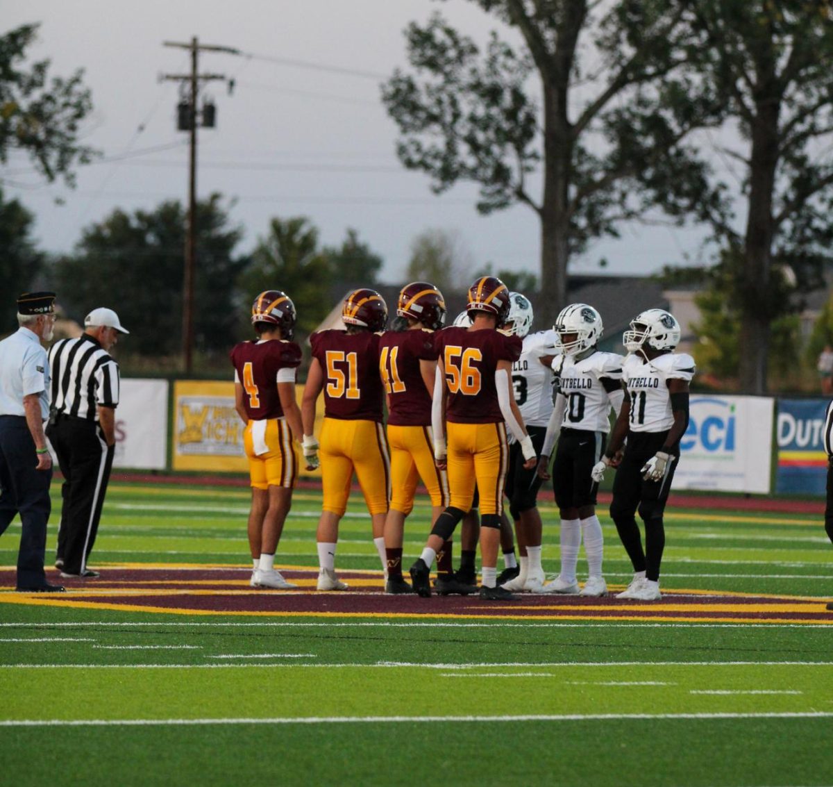 WHS team captains step toward Montbello team captains for the coin toss at the start of the game. The Wizards previously lost their first game 13-19 to the Green Mountain Rams, but they won this game 54-0.