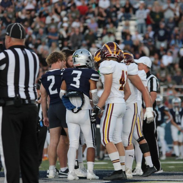 Captains of both WHS and SHS football teams meet in the middle of the field for the coin toss. This was the first rivalry game between the two schools thanks to a recent division change.