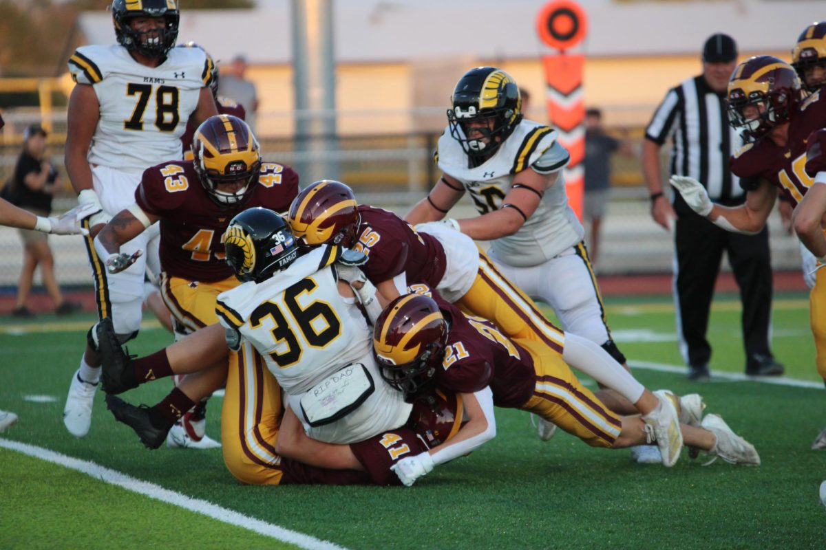 Football players take down #36 from the Green Mountain Rams during the game on Thursday, Aug. 29. Despite lots of excitement going in to the first game, it ended in a 13-19 loss.