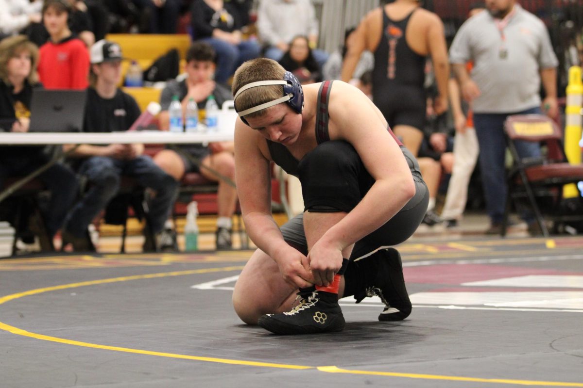 Grady Agone (11) prepares to wrestle in the 2024 Regional dual. Agone plays football and wrestles in addition to taking photos in his free time. 