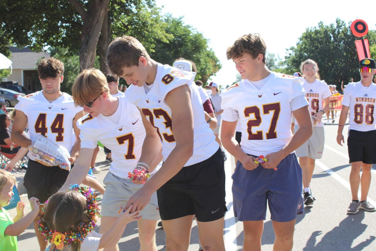 Football players hand out candy during the 2024 Harvest Festival Parade. This was the 102nd annual parade.