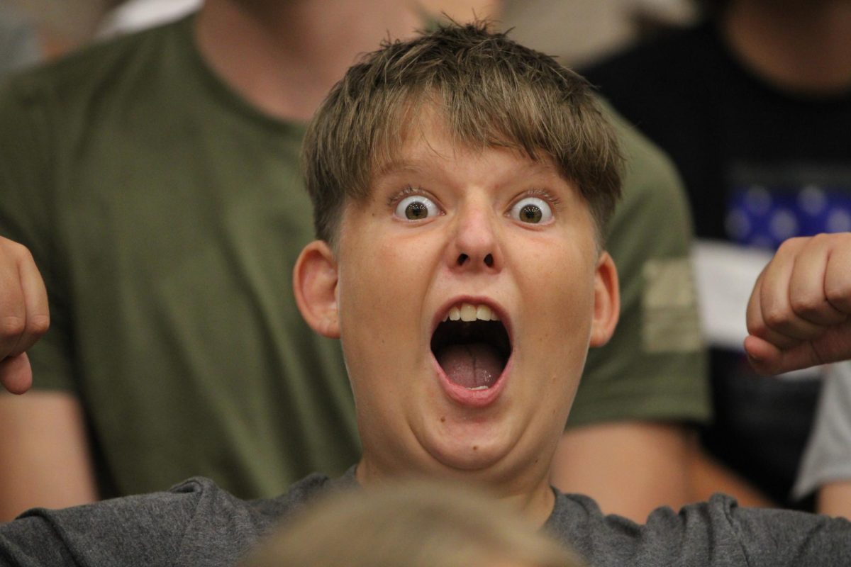 Griffen Dechario (9) shouts in the bleachers during freshman invasion. The Link Crew helped guide the freshmen through their first day of High School.