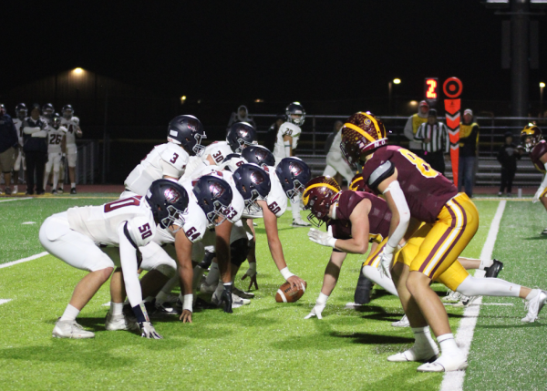 The defensive side for the Wizards works hard to keep Northridge from scoring a touchdown. The Wizards dominated Northridge 45-6 in the homecoming game.