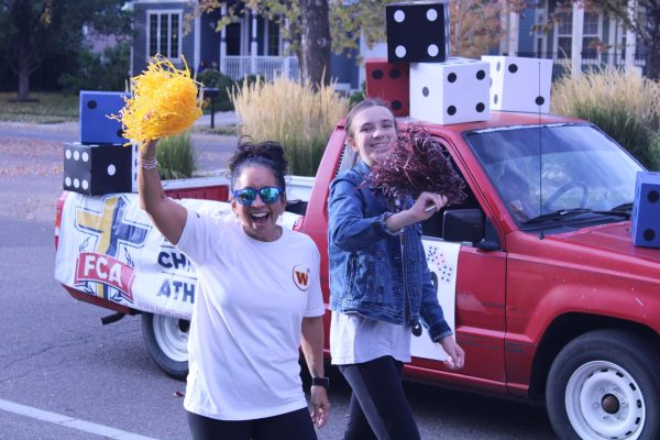 teacher and student walk in parade