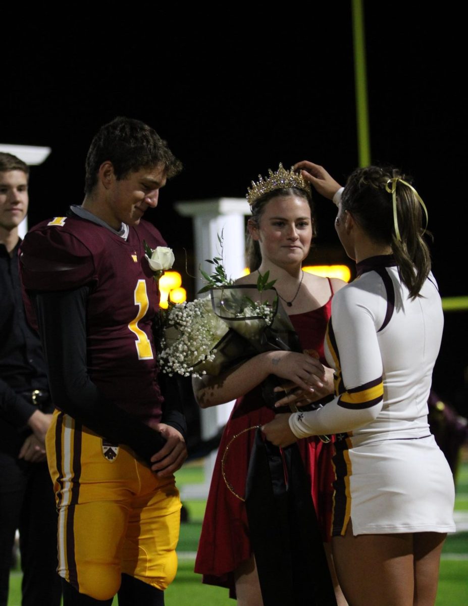 student crowned as homecoming queen during the football game