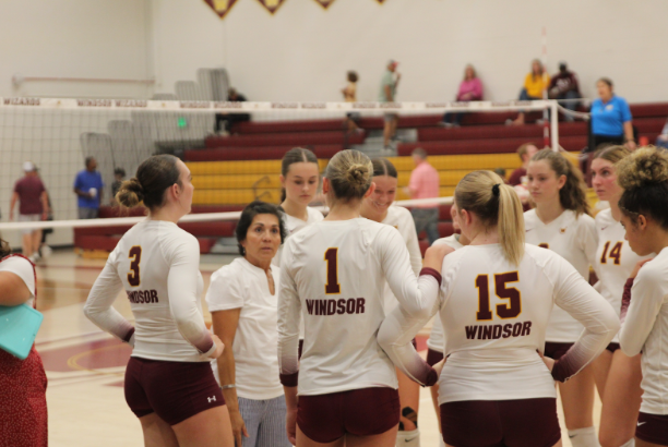 Presley Krasuski (10) and Jayda Nothdurft (10) and other players huddle and talk with Coach Huston. The team beat Poudre, winning in all three sets of the game.