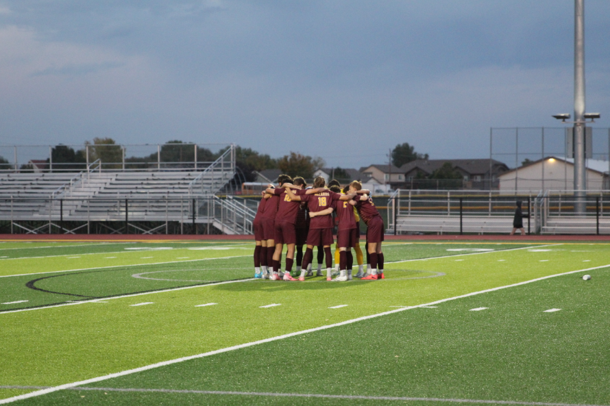 The boys varsity team huddles before their game agianst Greeley West on Tuesday, Oct. 8. The team won 8-2 and ended its losing streak.