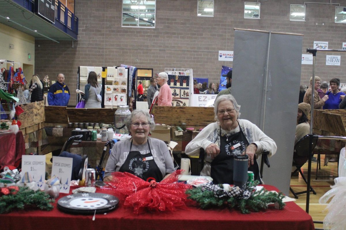 Jane Romey (left) and Kennie Bennett (right) sit at their booth at the Christmas in Windsor Craft Show on Saturday, Nov. 23. The event featured more than 100 vendors with homemade goods.