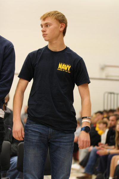 Student stands while wearing a Navy shirt