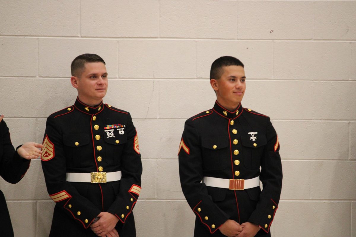 Former student and salutatorian Lucas Ng ('24) stands against the gym wall and listens to the assembly. He enlisted in the Marines in 2024 and just finished boot camp.