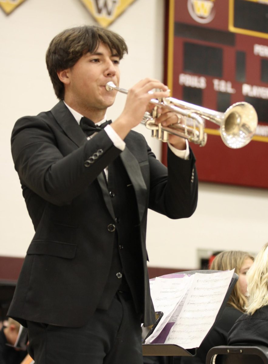 Marcelo Kolb (11) plays the taps on his trumpet, making cues for the veterans to rise when their branch was announced. "It is really important for the veterans because it's played at their funerals," Kolb said. "It was also really nerve wracking because it was just like me playing alone."