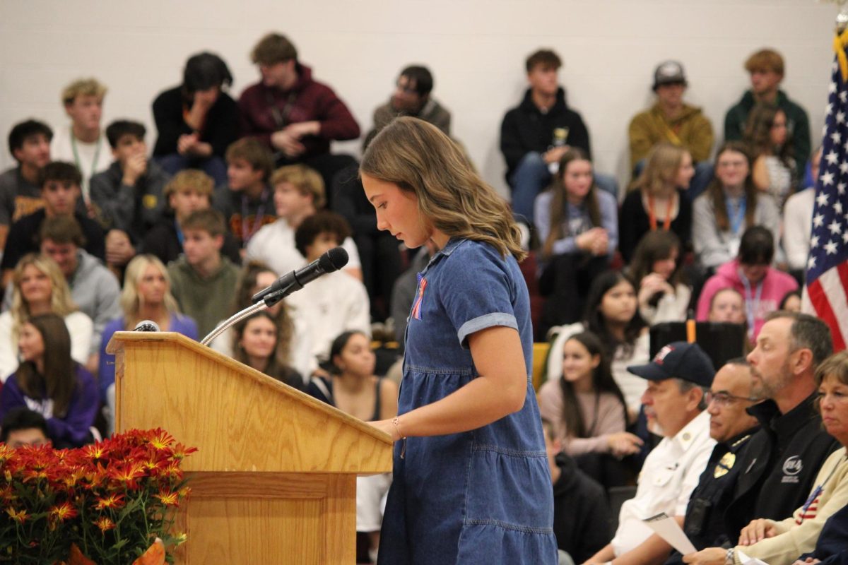 Madi Romme (12) stands at the podium and presents a speech. Her father, Scott Romme ,was previously enlisted in the military and started the Veteran's Day assembly tradition at WHS.