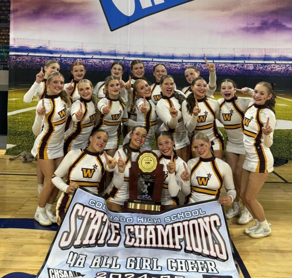 Caeli Wright (11) and the Windsor High School cheer team pose after taking first place at the state competition on Friday, Dec. 13. The team went all season undefeated: 7-0. (Liz Kampschroeder)