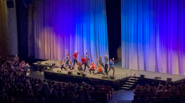 Student thespians perform on the main stage at ThesCon. Leah Gilmore (12) can be seen on the far right wearing a blue shirt.