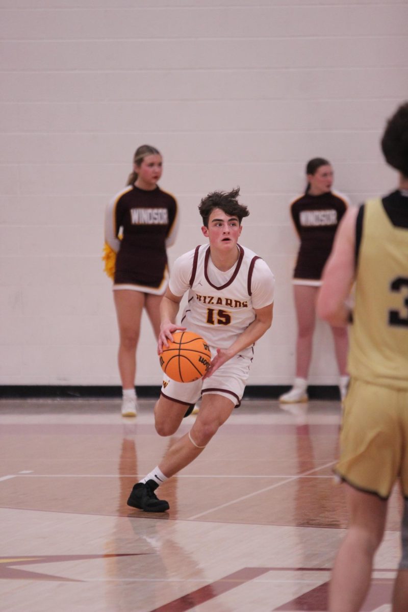 Brady Kingsley (11) dribbles the ball toward the Spartans half on Jan. 10. Kingsley provided the team dozens of key passes and points to aid in the team's victory against Greeley West.