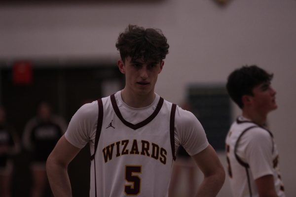 basketball player stands with hands on hips