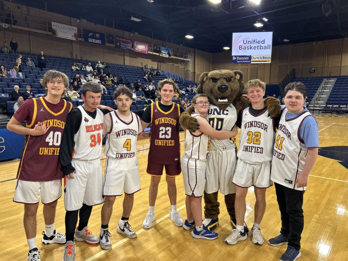 WHS athletes come together for a memorable moment with Klawz, the UNC mascot. Both teams demonstrated compassion and teamwork on and off the court. (Nicole Sigafoos)