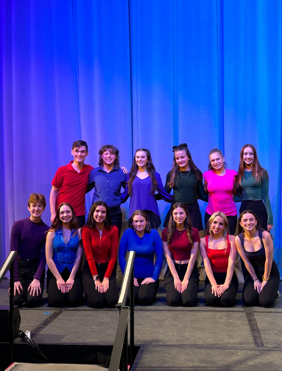 Leah Gilmore (12), sitting in the front row in the middle in blue, poses with ThesCon All State members. Gilmore performed with these students from high schools throughout Colorado during the opening ceremony at ThesCon. (Provided by Leah Gilmore)