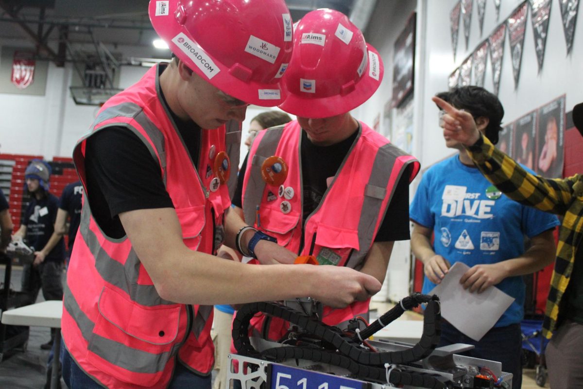 Michael Webb (12) and Grady Thorne (12) stressfully modify their team's robot between matches. "Overall, you just have to be confident that it's gonna get done," Webb said. "Even though it may take five minutes and you only have five minutes, you just have to understand that if it doesn't get done, it's gonna screw you over."