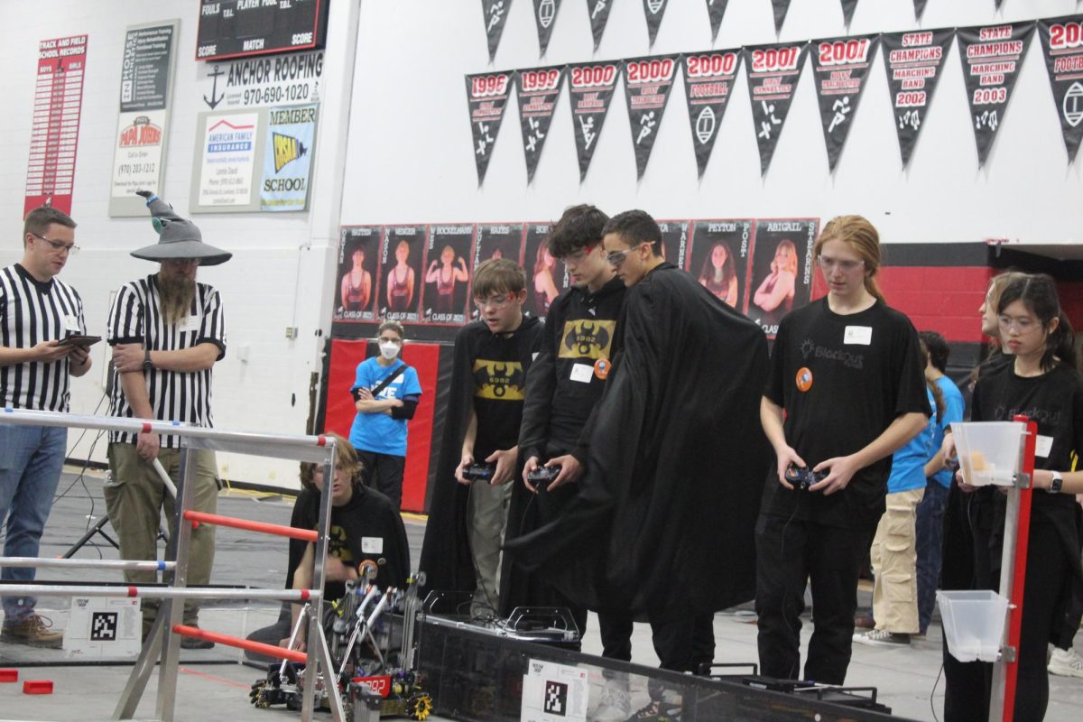 Torin Bartmann (10) and Gavin Ditmer (10) control their team's robot while Adam Kirkpatrick (12) advises. "I get to lead my own team, which is nice," Kirkpatrick said. "I like having a good, big role in, like, design and coordinating people."