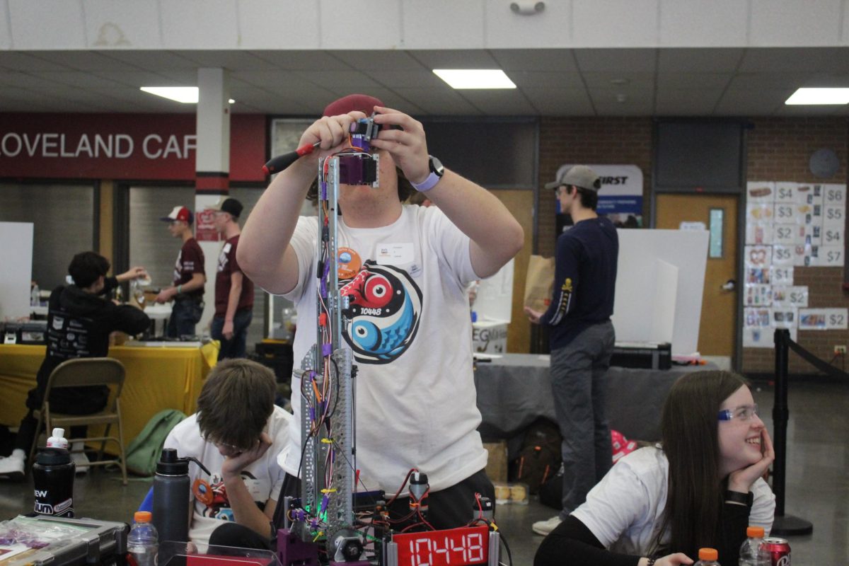 Cooper Dunworth (10) alters his team's robot. "I enjoy getting to build things and just think of new ideas, solve problems and work as a team," Dunworth said.