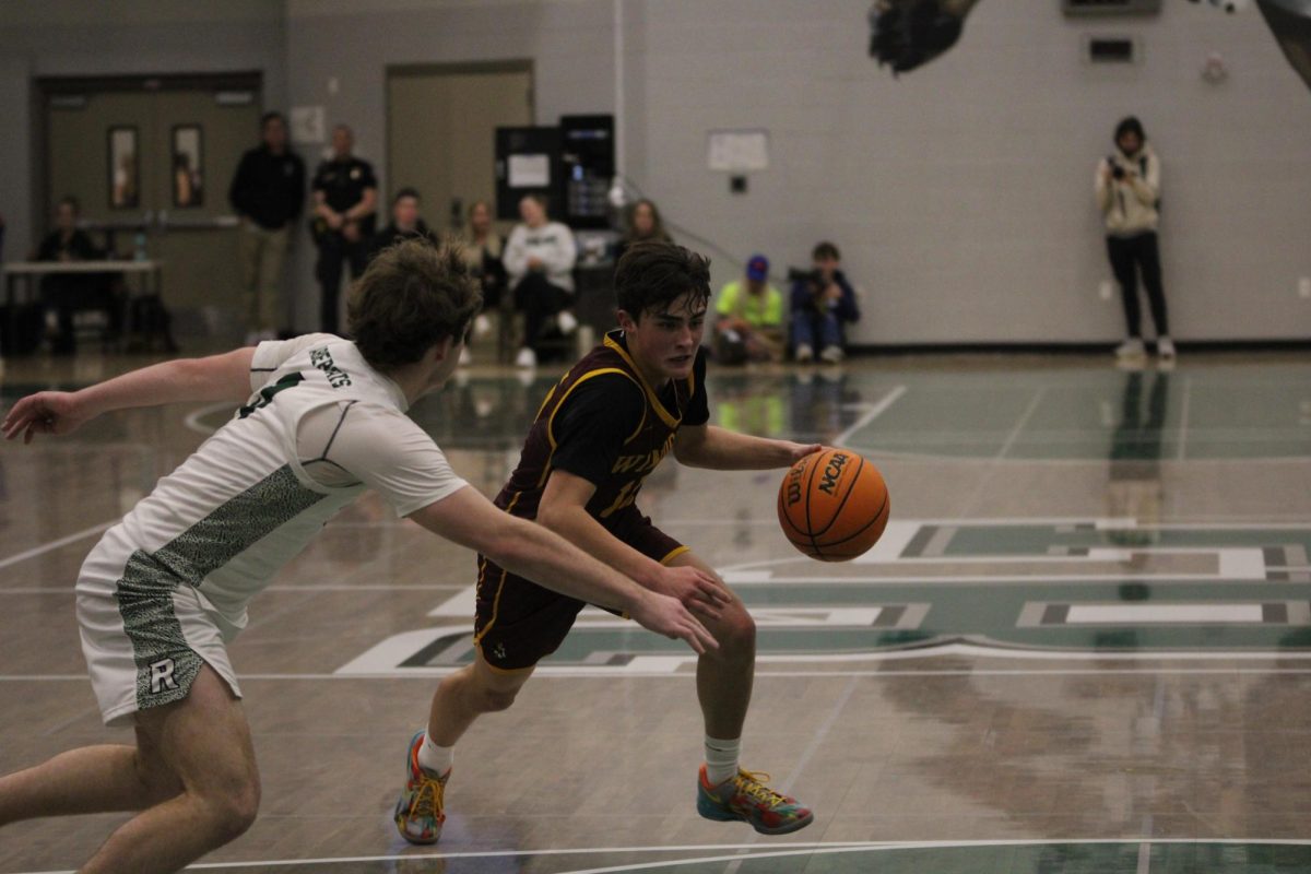 Brady Kingsley (11) dribbles the ball toward the basket in efforts of making a layup. Kingsley was fouled on the play and awarded two free-throws. 