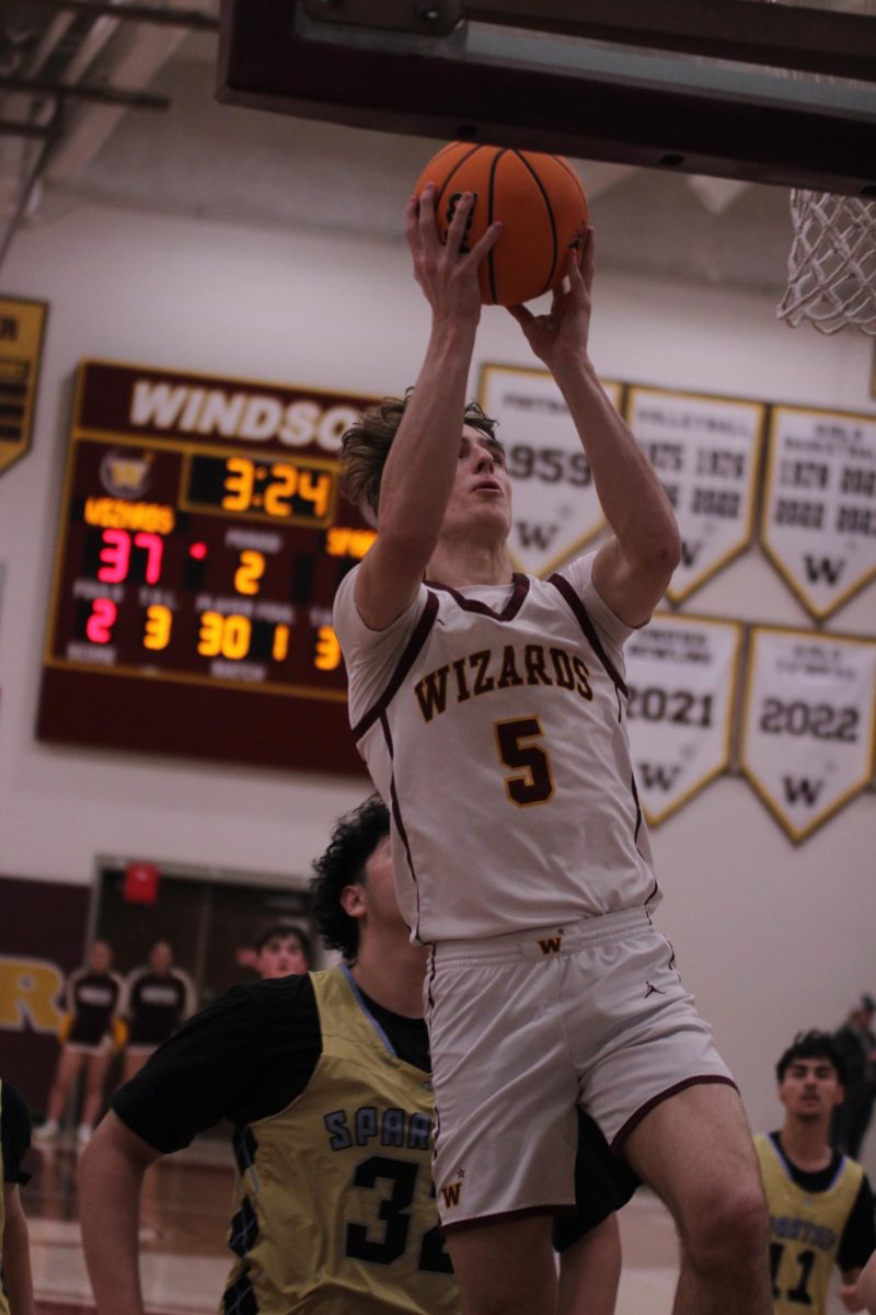 Shooting guard Madden Smiley (11) goes in to make a basket during the game against Greeley West on Jan. 10. The game ended 90-25 and the team is currently 13-4 for the season.