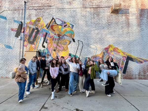 Students stand in a group and pose