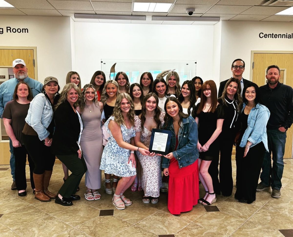 The cheer team poses for a photo in Februarly while being honored for their State Championship 4A All Girl Title won in December. This was the first ever state championship title won by a WHS cheer team in the history of the school. (Photo provided by Liz Kampschroeder)
